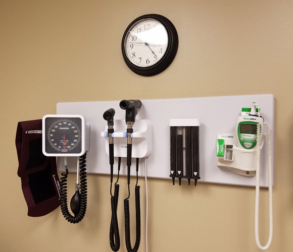 Medical devices hung on a wall in a doctors office.