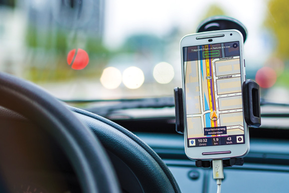 A smartphone being used as a GPS on a car dashboard.